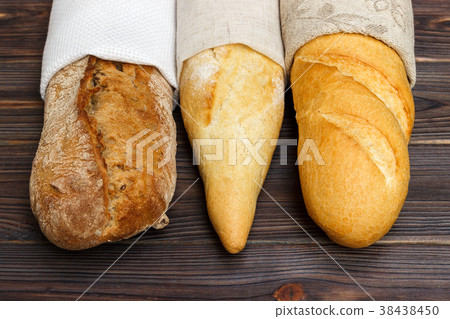Homemade baguettes on wooden table. close up 38438450