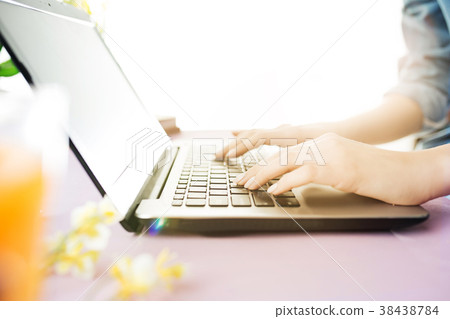 Woman and fruit diet while working on computer in Woman and fruit diet while working on computer in 38438784