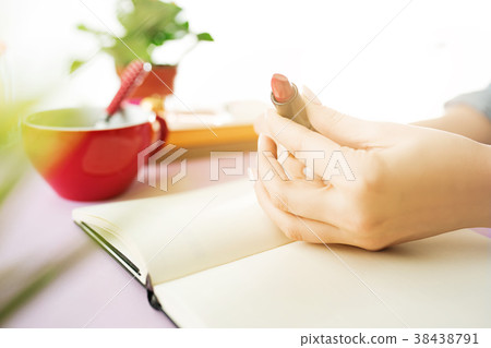 The female hands holding pomade. The trendy pink The female hands holding pomade. The trendy pink 38438791