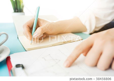 The male hands holding pen. The trendy blue desk. The male hands holding pen. The trendy blue desk. 38438806