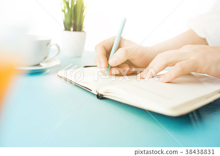 The male hands holding pen. The trendy blue desk. The male hands holding pen. The trendy blue desk. 38438831
