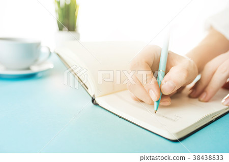 The male hands holding pen. The trendy blue desk. The male hands holding pen. The trendy blue desk. 38438833