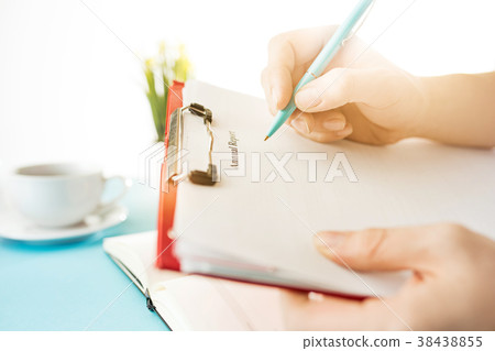 The male hands holding pen. The trendy blue desk. The male hands holding pen. The trendy blue desk. 38438855