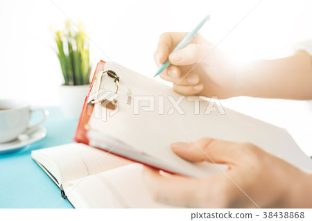 The male hands holding pen. The trendy blue desk. The male hands holding pen. The trendy blue desk. 38438868