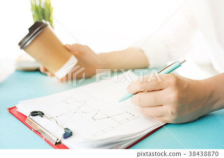 The male hands holding pen and coffee. The trendy The male hands holding pen and coffee. The trendy 38438870