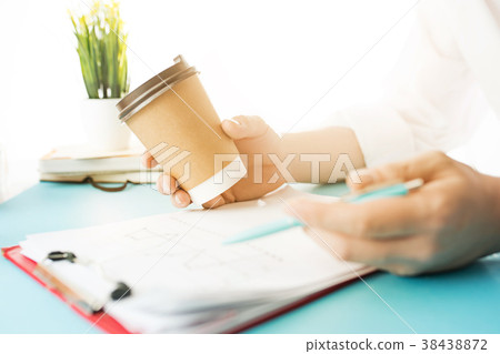 The male hands holding pen and coffee. The trendy The male hands holding pen and coffee. The trendy 38438872