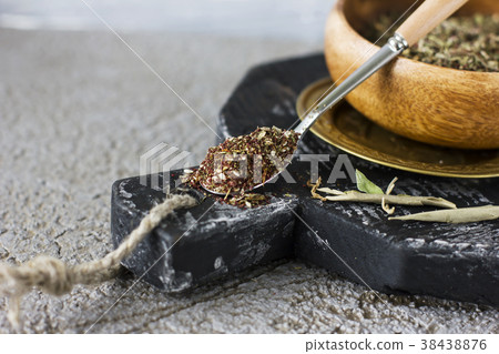 Dry spices in wooden Cup on gray background Dry spices in wooden Cup on gray background 38438876