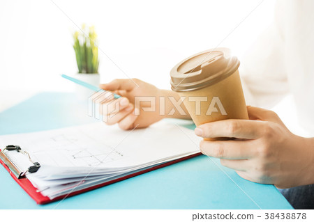The male hands holding pen and coffee. The trendy The male hands holding pen and coffee. The trendy 38438878