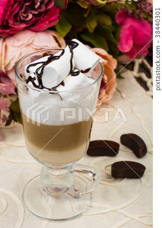 Tall glass with latte and marshmallow on wooden 38440301