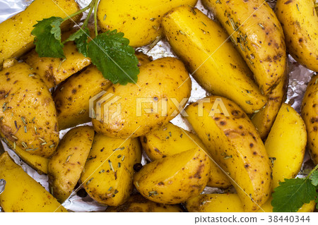 Slices of raw potatoes with spices on foil for Slices of raw potatoes with spices on foil for 38440344
