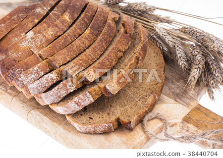 Rye bread, sliced on a kitchen wooden board, ears Rye bread, sliced on a kitchen wooden board, ears 38440704