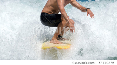 Surfer rides what water r 38440876