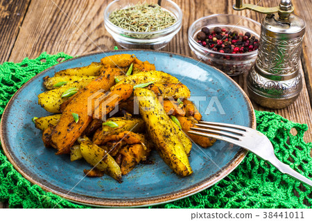 Baked vegetables, potatoes and pumpkin with herbs 38441011