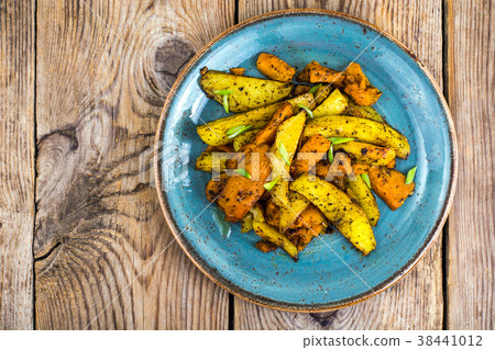 Baked vegetables, potatoes and pumpkin with herbs 38441012
