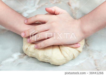 Children hands kneads dough Children hands kneads dough 38441266