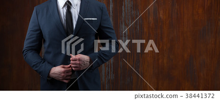 body of a businessman in a suit on rusty 38441372