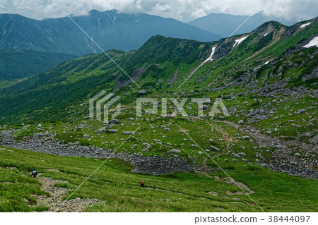 Mountain climber going the curl of Goro Kurobe in the Northern Alps 38444097