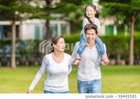 Happy family piggybacking adorable little daughter Happy family piggybacking adorable little daughter 38445583
