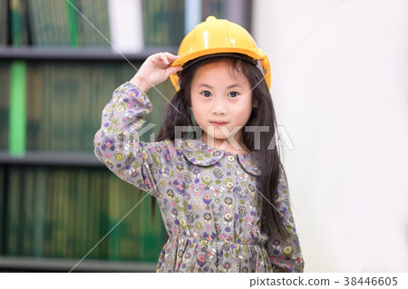 Cute girl wearing yellow engineer helmet. Cute girl wearing yellow engineer helmet. 38446605