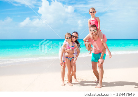 Happy beautiful family on a tropical beach 38447649