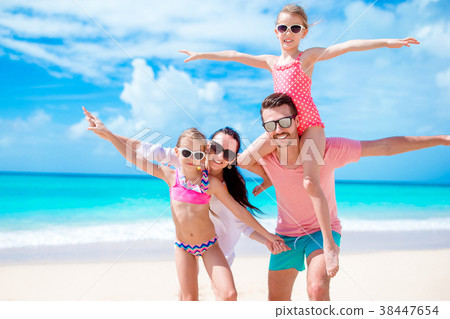 Happy beautiful family on white beach having fun 38447654