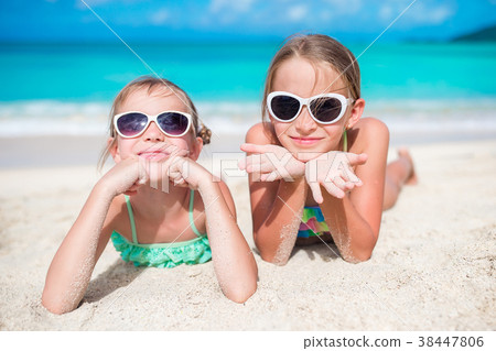 Adorable little sisters at beach during summer Adorable little sisters at beach during summer 38447806