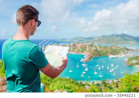 Young tourist man with map background of English Young tourist man with map background of English 38448211