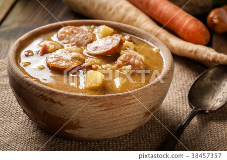 Wooden bowl of split pea soup 38457357