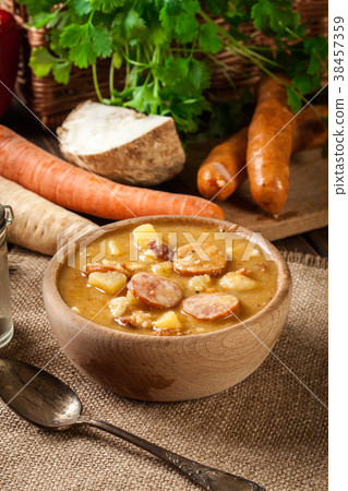 Wooden bowl of split pea soup 38457359