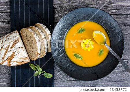 Pumpkin soup in black plate 38458772