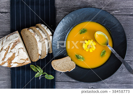 Pumpkin soup in black plate 38458773