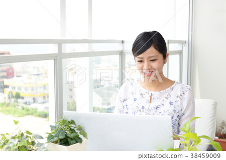 A woman enjoying a laptop computer 38459009