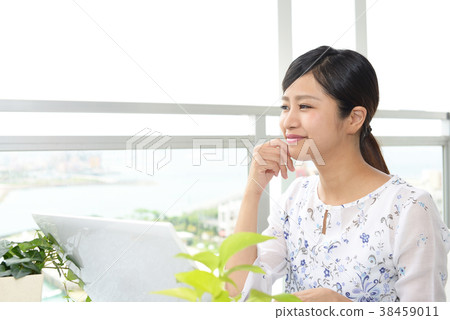 A woman enjoying a laptop computer 38459011