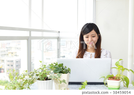 A woman enjoying a laptop computer 38459054