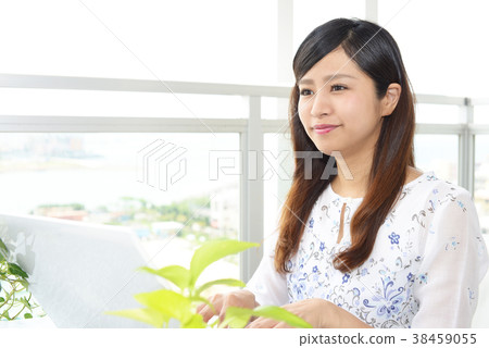 A woman enjoying a laptop computer 38459055