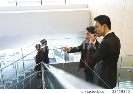 Business person talking on the stairs Business person talking on the stairs 38459840