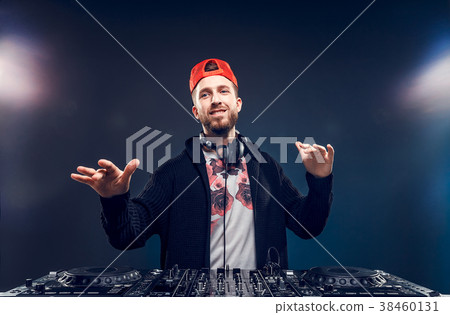 Man play music on a dj's mixer. Studio shot. Light Man play music on a dj's mixer. Studio shot. Light 38460131