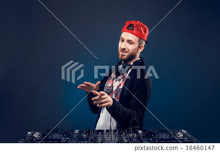 Man play music on a dj's mixer. Studio shot.  38460147