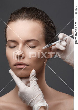 Portrait of young Caucasian woman getting cosmetic Portrait of young Caucasian woman getting cosmetic 38460225