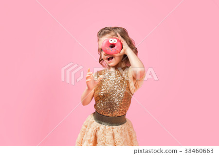 Girl looking through donut hole 38460663