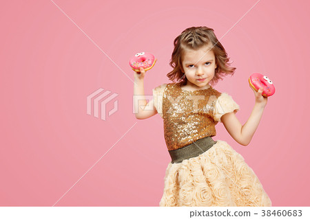 Little girl in dress with donuts 38460683