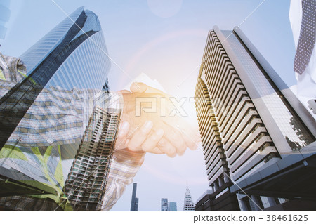 Businessmen and engineers are shaking hands. Businessmen and engineers are shaking hands. 38461625