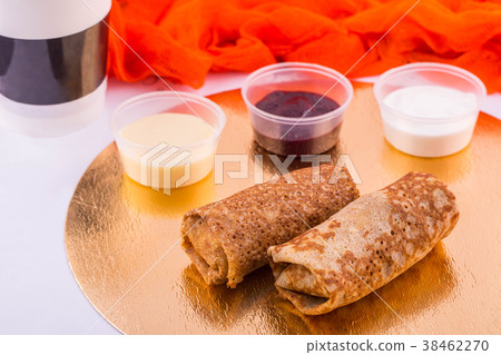 Pancakes with stuffing, are served with sour cream Pancakes with stuffing, are served with sour cream 38462270