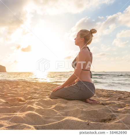 Woman relaxing on sea beach at sunset. Woman relaxing on sea beach at sunset. 38462690