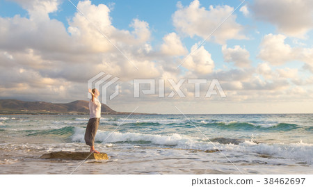 Free Happy Woman Enjoying Sunset on Sandy Beach 38462697