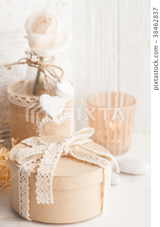 Beautiful tea rose in bottle with lit candle 38462837