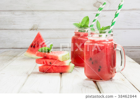 Summer healthy watermelon smoothie on white board Summer healthy watermelon smoothie on white board 38462844