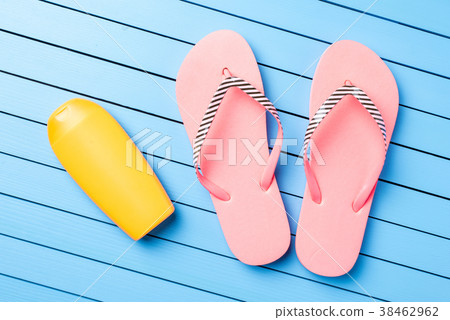 Pink flip flops on blue wooden table 38462962