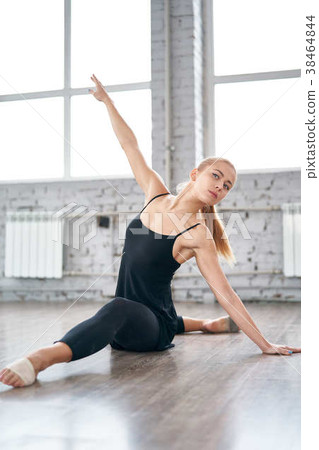 Young woman in sportswear doing stretching Young woman in sportswear doing stretching 38464844