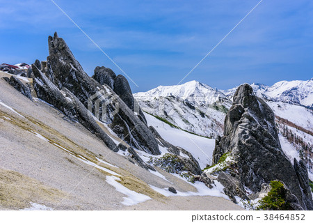 Snowy Mountain Range And Dolphin Rock Stock Photo